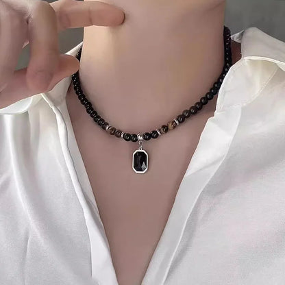 Collier de perles naturelles oeil de tigre et noires pendentif rectangle pierre noire homme