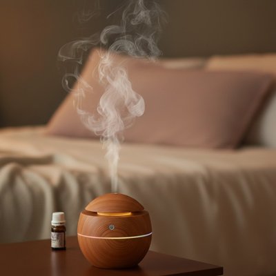 Humidificateur d'air sur table de nuit diffusant des huiles essentielles ambiance zen